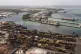 Cargo containers sit stacked as cranes load and unload conta