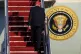President Donald Trump walks up the stairs to board Air Forc