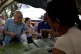 A customer buys about 100 grams of raisins from a market sta