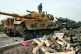 Turkish soldiers prepare their tanks next to empty shells at
