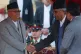 Nepal's new Prime Minister KP Sharma Oli shakes hands with h