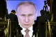 Journalists watch as Russian President Vladimir Putin gives 