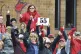 Teachers give a thumbs-up in front of Woodsdale Elementary i