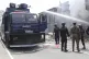 Sri Lankan police officers attempt to douse burning shops in