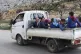 Kurds in the back of a truck flee from their village where T