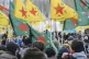 Demonstrators carry flags of the YPG as they protest against