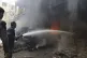 A man puts out a fire following air strikes in Douma, in the