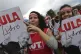 Demonstrators carry signs written that read 