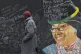A pedestrian passes a wall mural dedicated to anti-apartheid