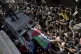 Palestinian mourners carry the body of a volunteer paramedic