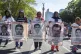Women display some of the faces of the 43 missing students d