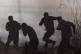 Palestinians protesters run from tear gas fired by Israeli t