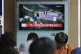 A TV screen shows a satellite image of North Korea's Sohae l