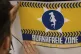 A man glues a poster reading 