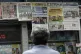 A man reads the headlines announcing the results of the Braz