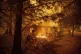 Firefighters work to keep flames from spreading through as a