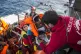 A baby is loaded into the rescue vessel of the Spanish NGO P