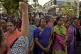 A woman shouts slogans against gender discrimination as they