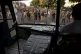 Policemen and others view state-owned buses that were vandal