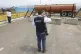 An immigration official observes a fuel tanker, cargo traile