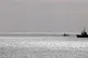 The Mare Jonio ship (right) is flanked by Italian Coast Guar