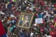 A man holds up a framed image of President Nicolas Maduro du