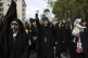 A protester chants while holding a poster of Iranian Supreme