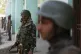 Indian paramilitary soldiers stand guard outside a polling s