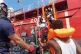 Rescued migrants are helped boarding the Ocean Viking ship, 