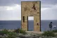 A woman stands by the Door of Europe, the monument by Italia