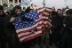 Protesters burn a US flag during a demonstration over the US