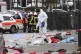 Police and rescue workers stand next to the scene of the acc