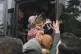 Migrants struggle to board a bus to go to the Greek border, 
