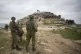 Israeli soldiers take position as Palestinian demonstrators 
