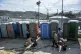 Migrants pull fire extinguishers in Moria refugee camp on th