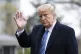 President Donald Trump waves as he walks from Marine One as 
