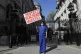 Doctor Meenal Viz holds a banner as she protests outside Dow