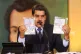 President Nicolas Maduro shows the identification documents 
