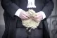 An advocate carrying his wig outside court