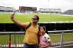 Cricket fans Rajesh Gupta with his daughter inside an empty 