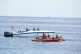 Men in a gunboat flying the Libyan flag sail past a Sea Eye 