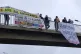 Stand Up to Racism activists carry out a banner drop near to