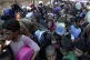 Palestinians line up for food distribution in Deir al-Balah,