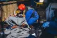 A member of the crew tends to a rescued refugee