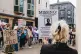 People gather outside a hotel in Brighton to protest against