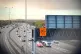Activists from Just Stop Oil hanging a banner above the M25