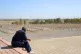 A man looks at the graves of those killed by Saddam Hussein