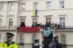Police stand guard as the squatters occupy the balcony on bi