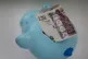 Money in a piggy bank at a home in Ashford, Kent, January 6,
