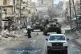 Russian soliders drive through Aleppo in December 2016